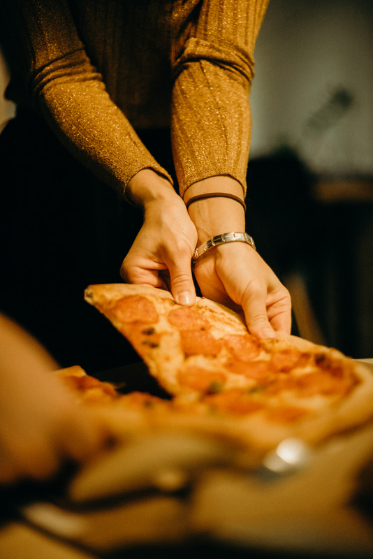 Canva - Woman Picking Pizza
