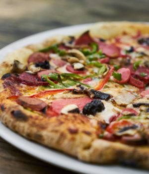 Delicious pizza served on porcelain plate Delicious pizza served on porcelain plate